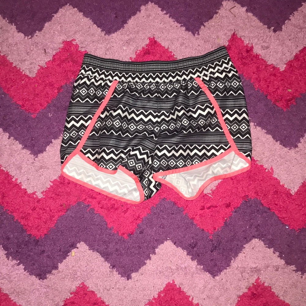 Black and white designed shorts with coral accents